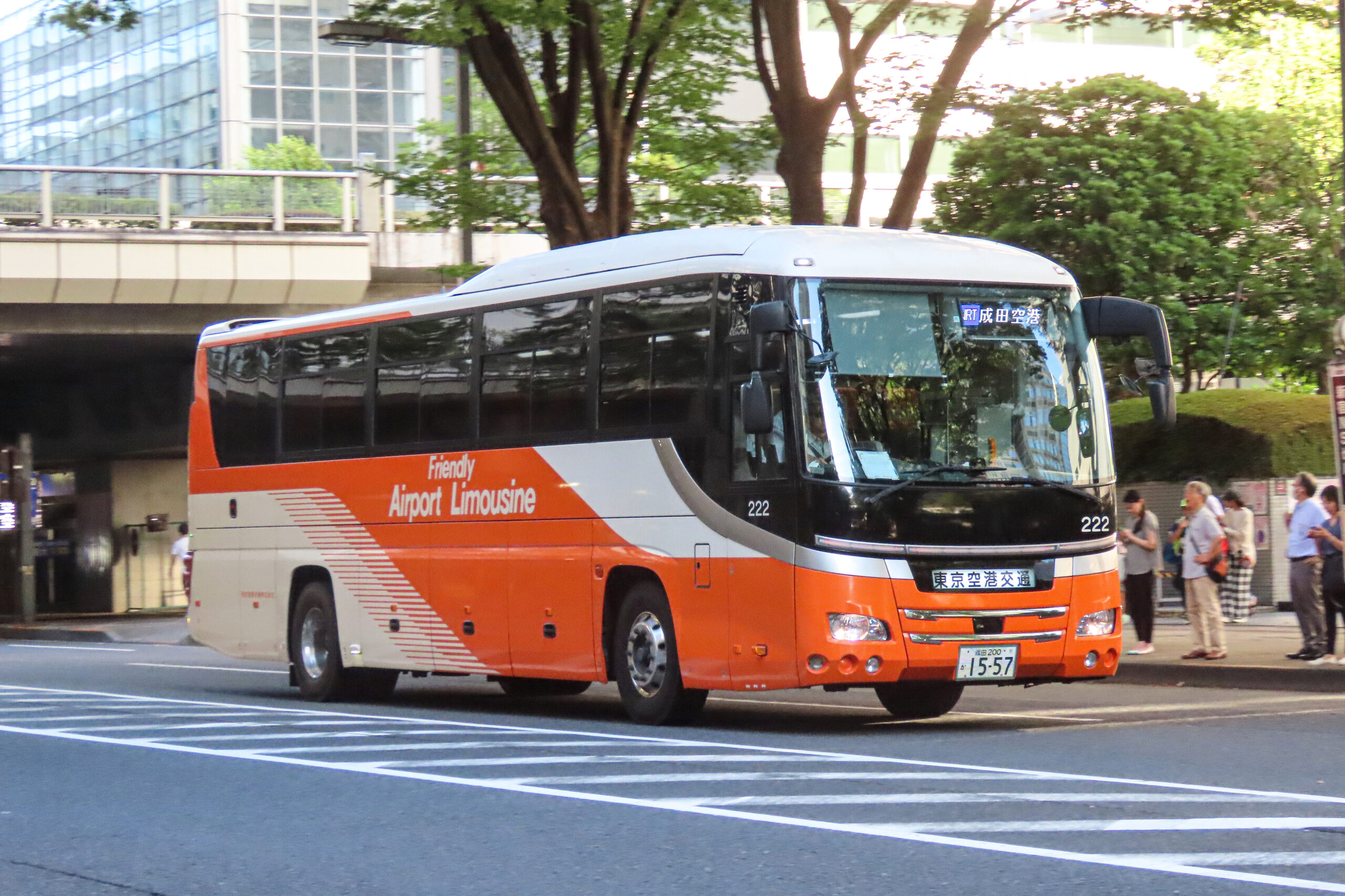 Orange and white airport limousine bus driving near Shinjuku in Tokyo