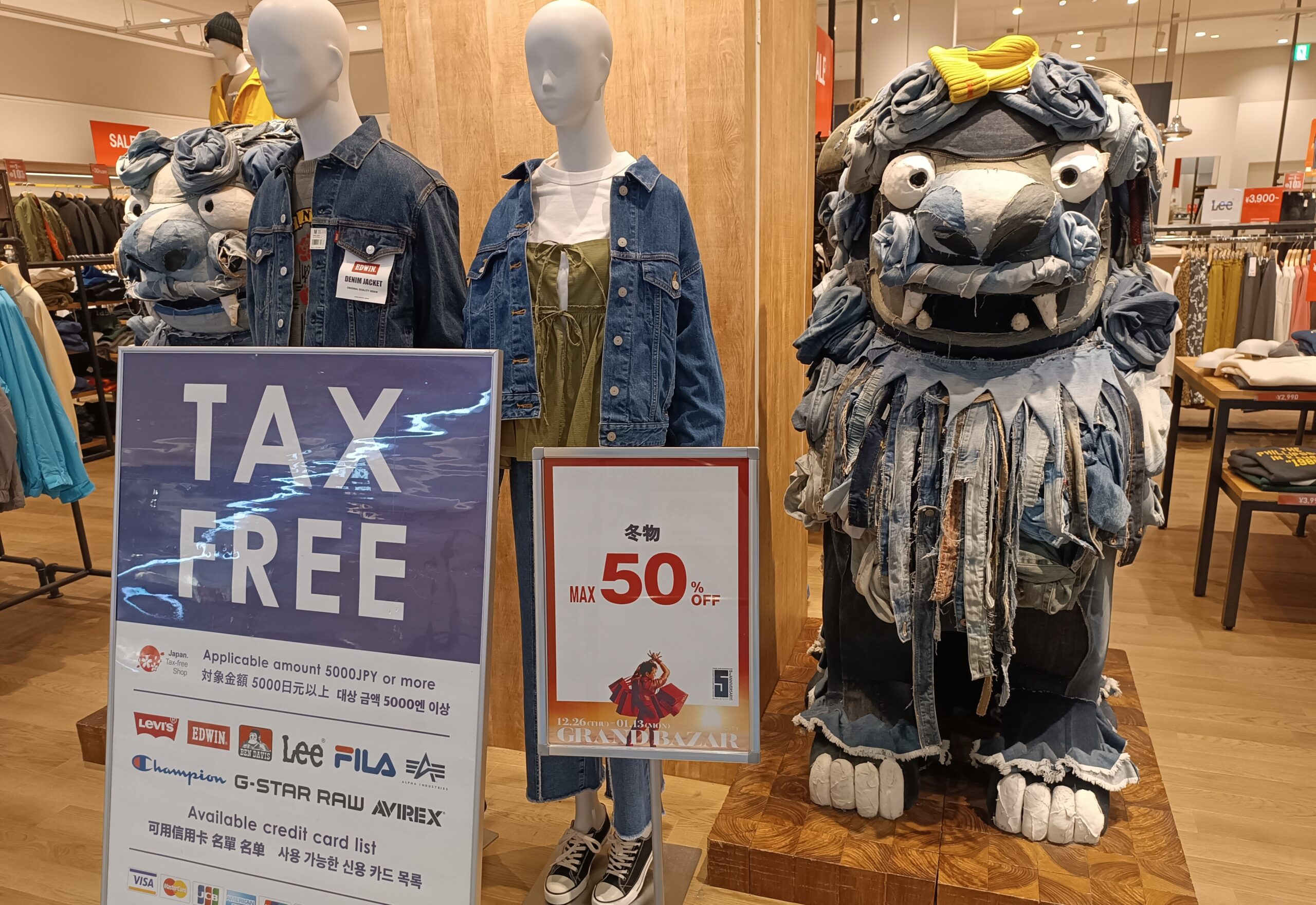 Tax Free sign beside clothing displays in a Japanese retail store