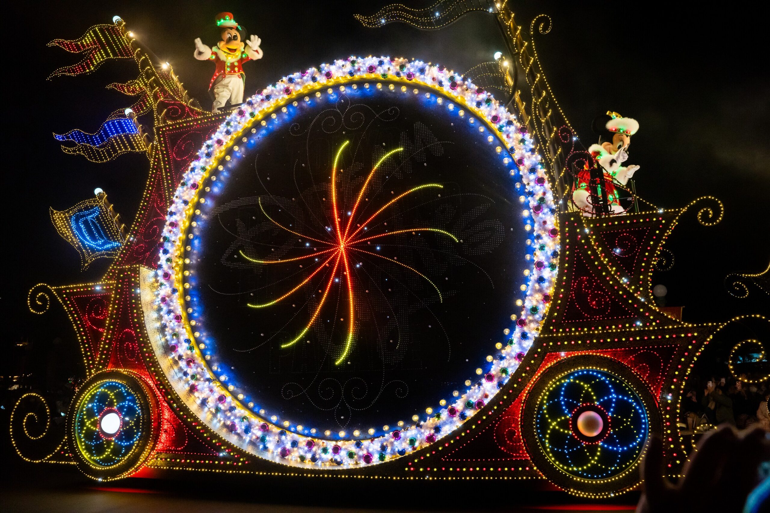 Colorful illuminated float moving through Tokyo Disneyland at night