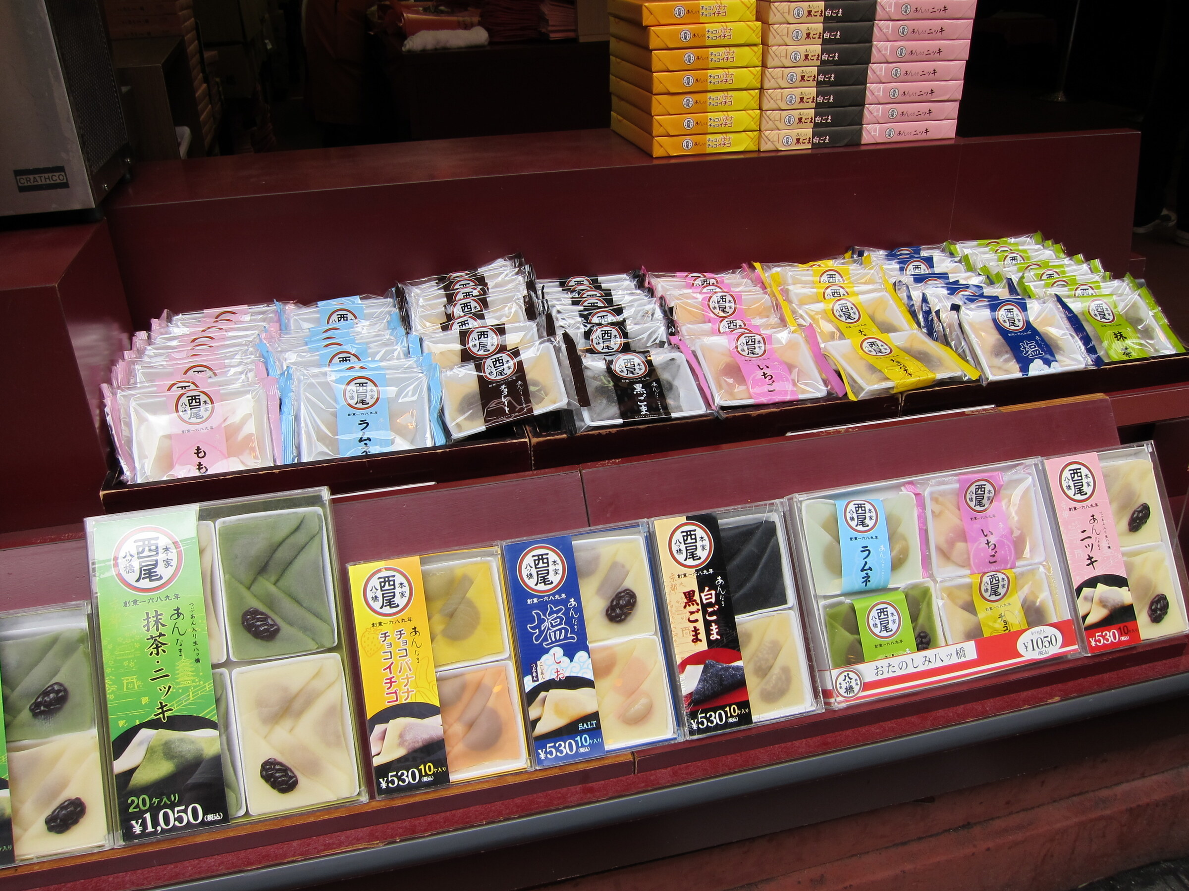 Individually packaged yatsuhashi sweets displayed at a Kyoto shop counter