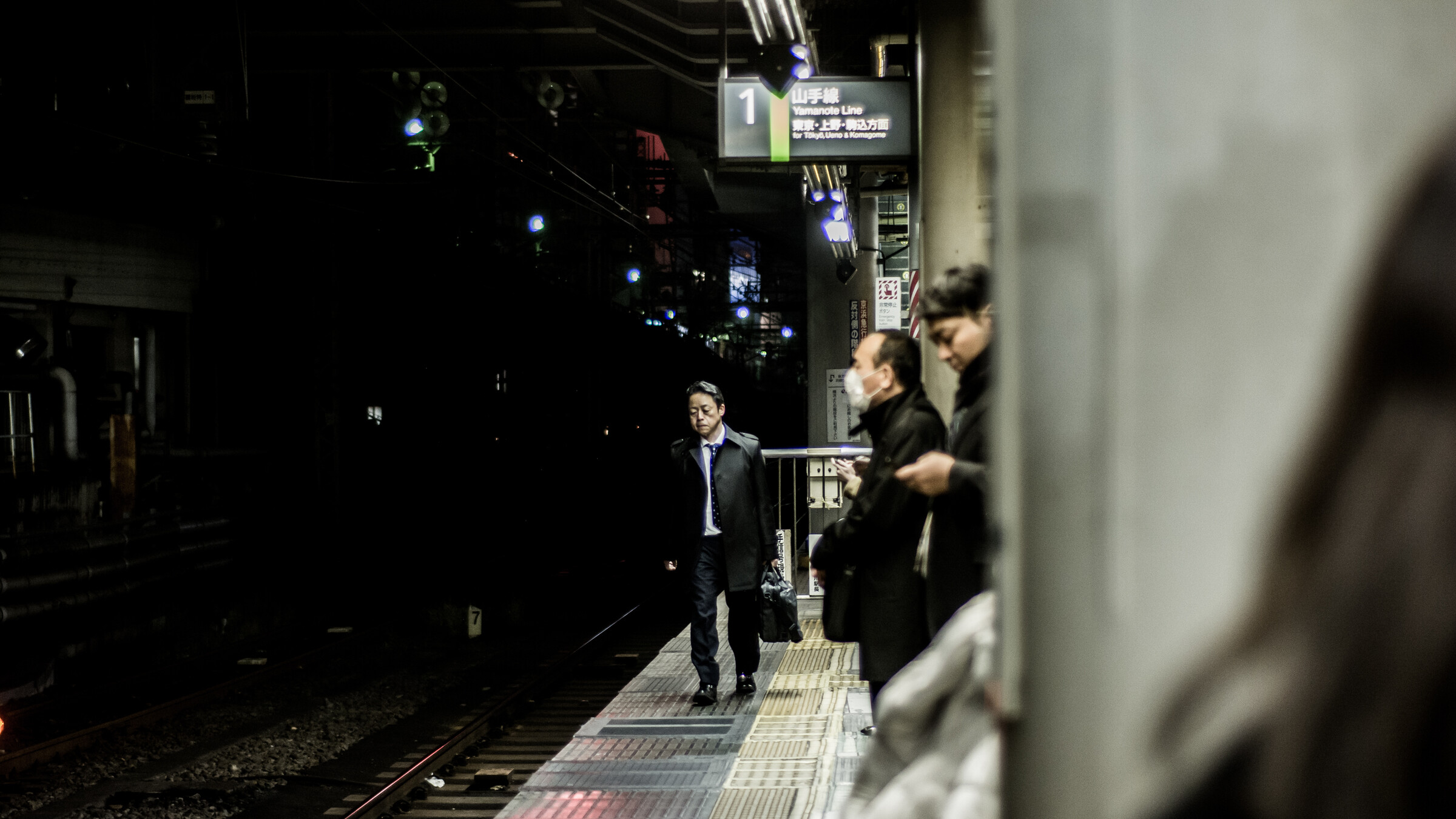 Passengers waiting for a local train at a Japanese station