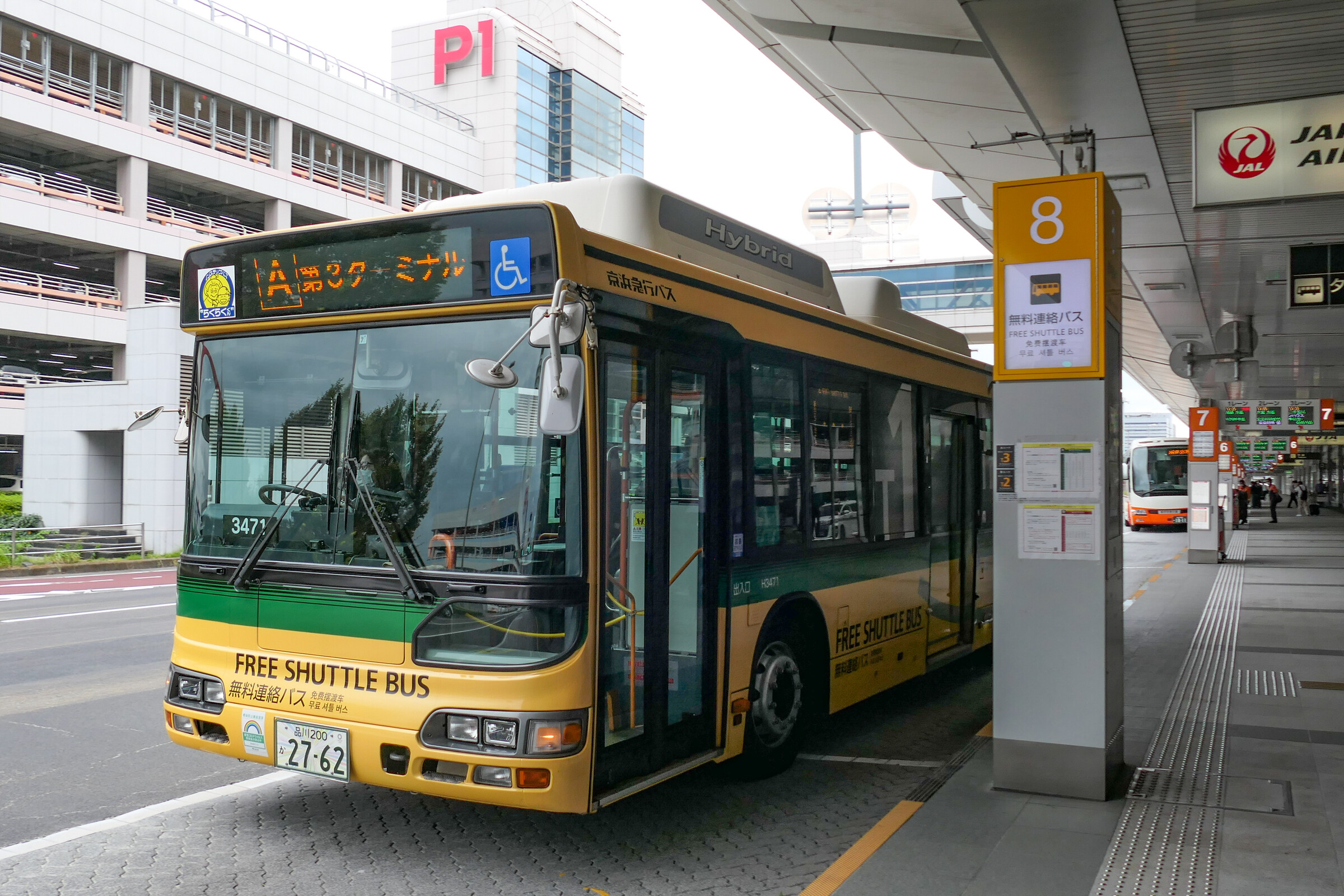 Marked shuttle bus stop outside Haneda Airport