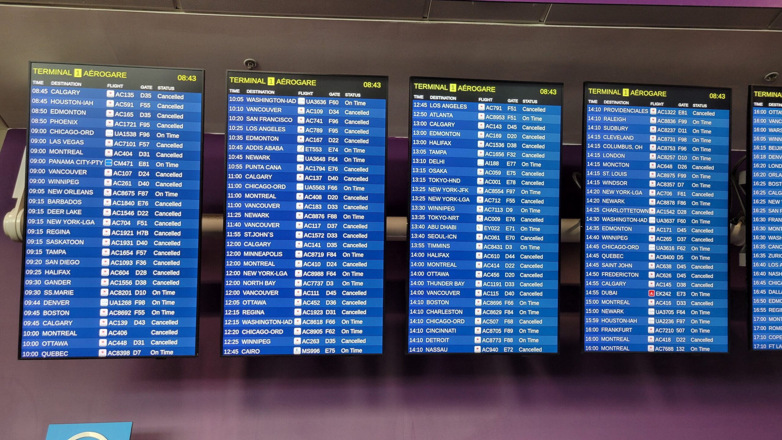 Airport departure boards showing multiple cancelled flights