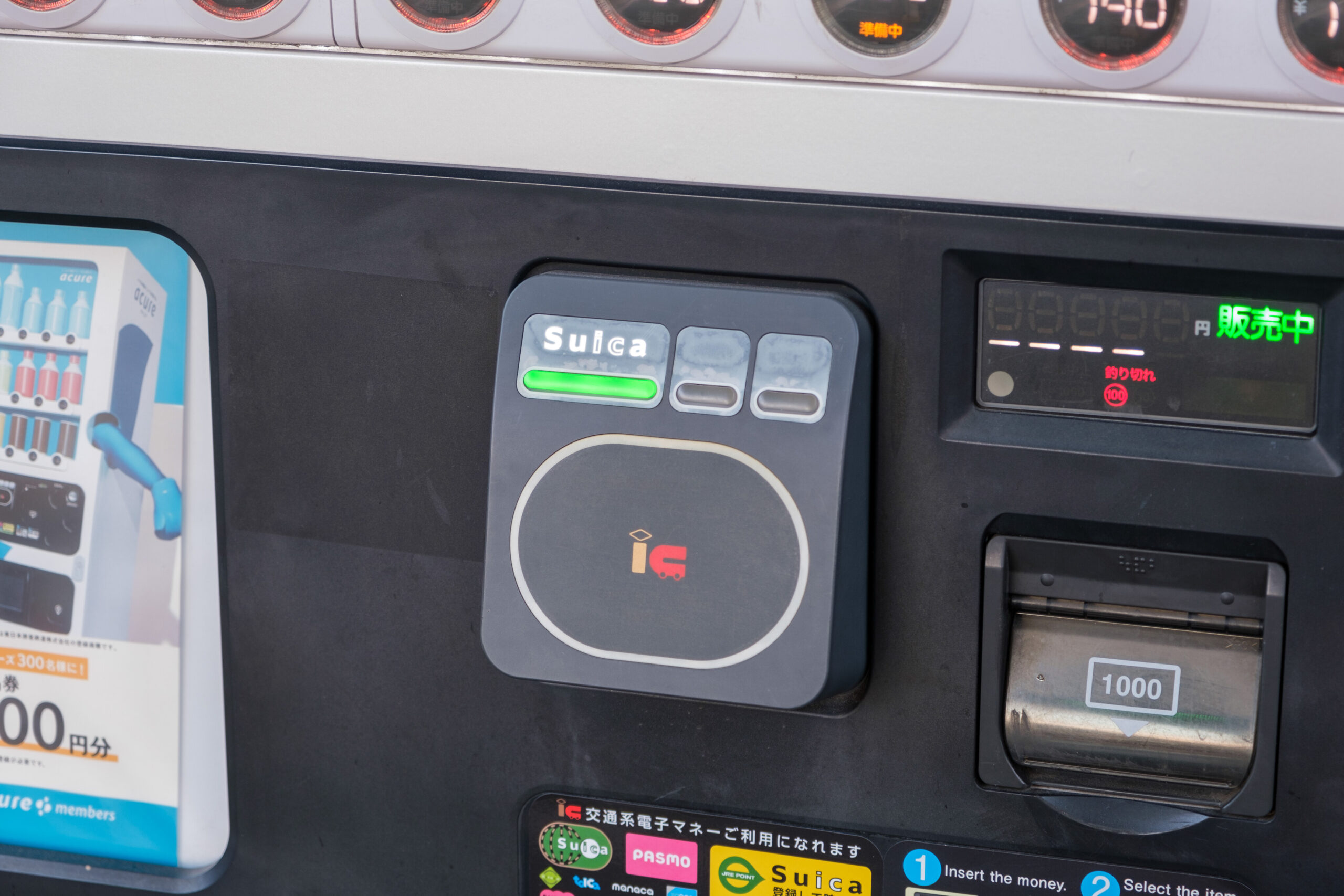 Suica contactless payment reader and cash slot on a vending machine