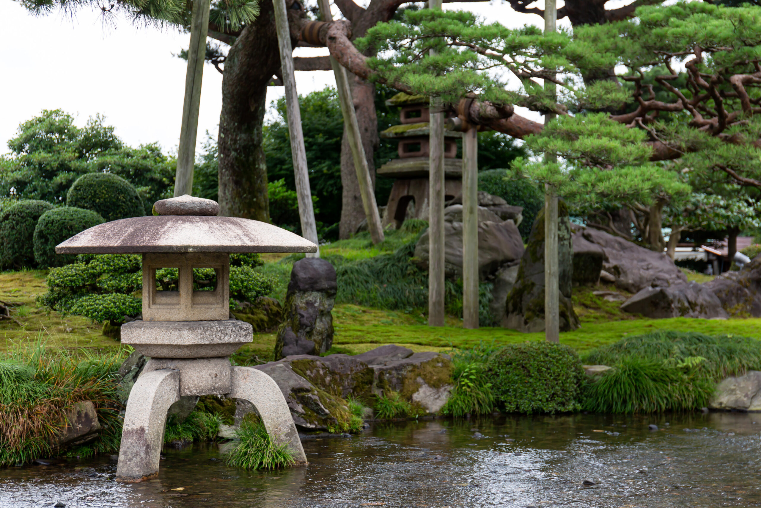 Stone lantern, pond and pine trees in Kenrokuen Garden, Kanazawa