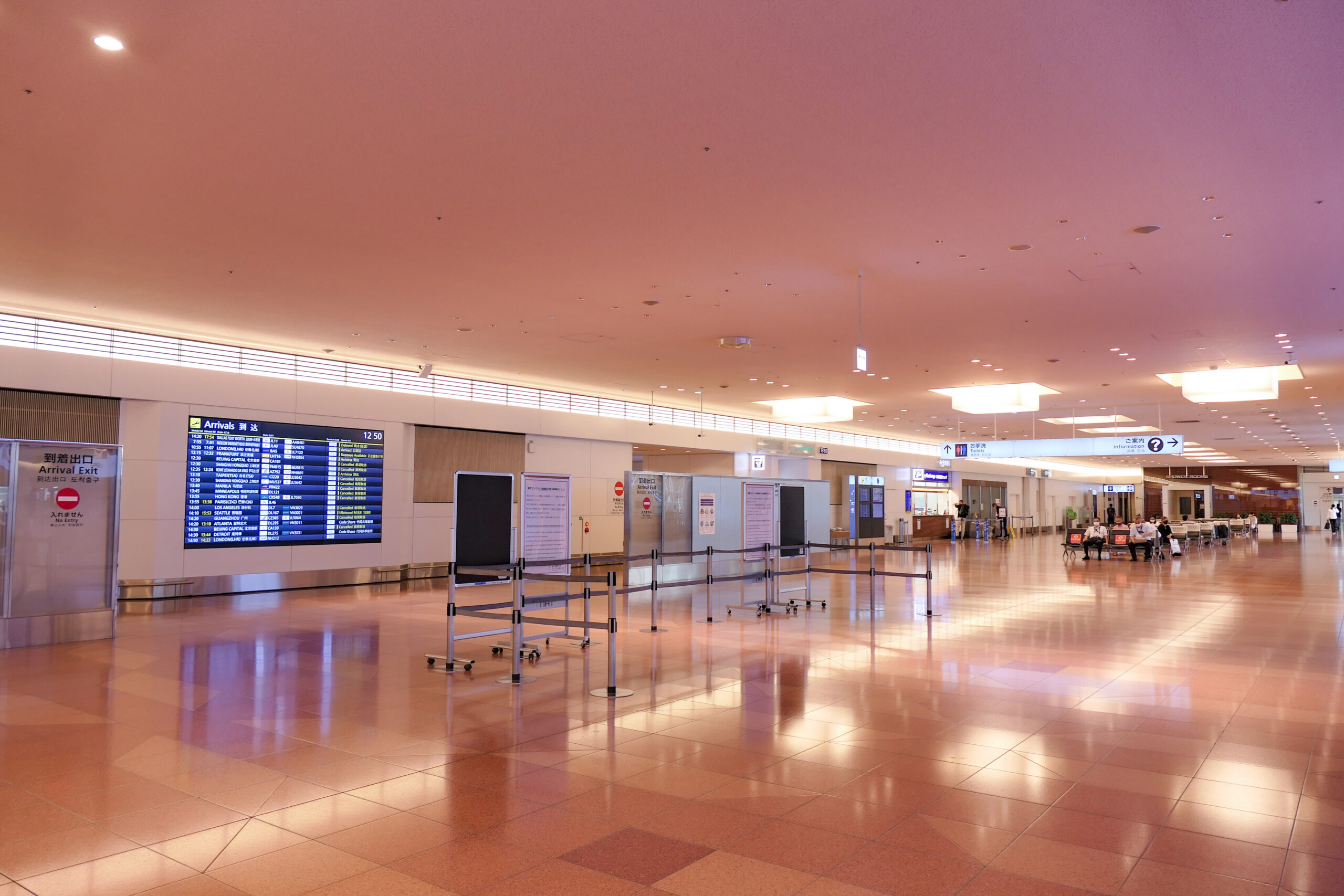 International arrivals lobby and flight information display at Haneda Airport