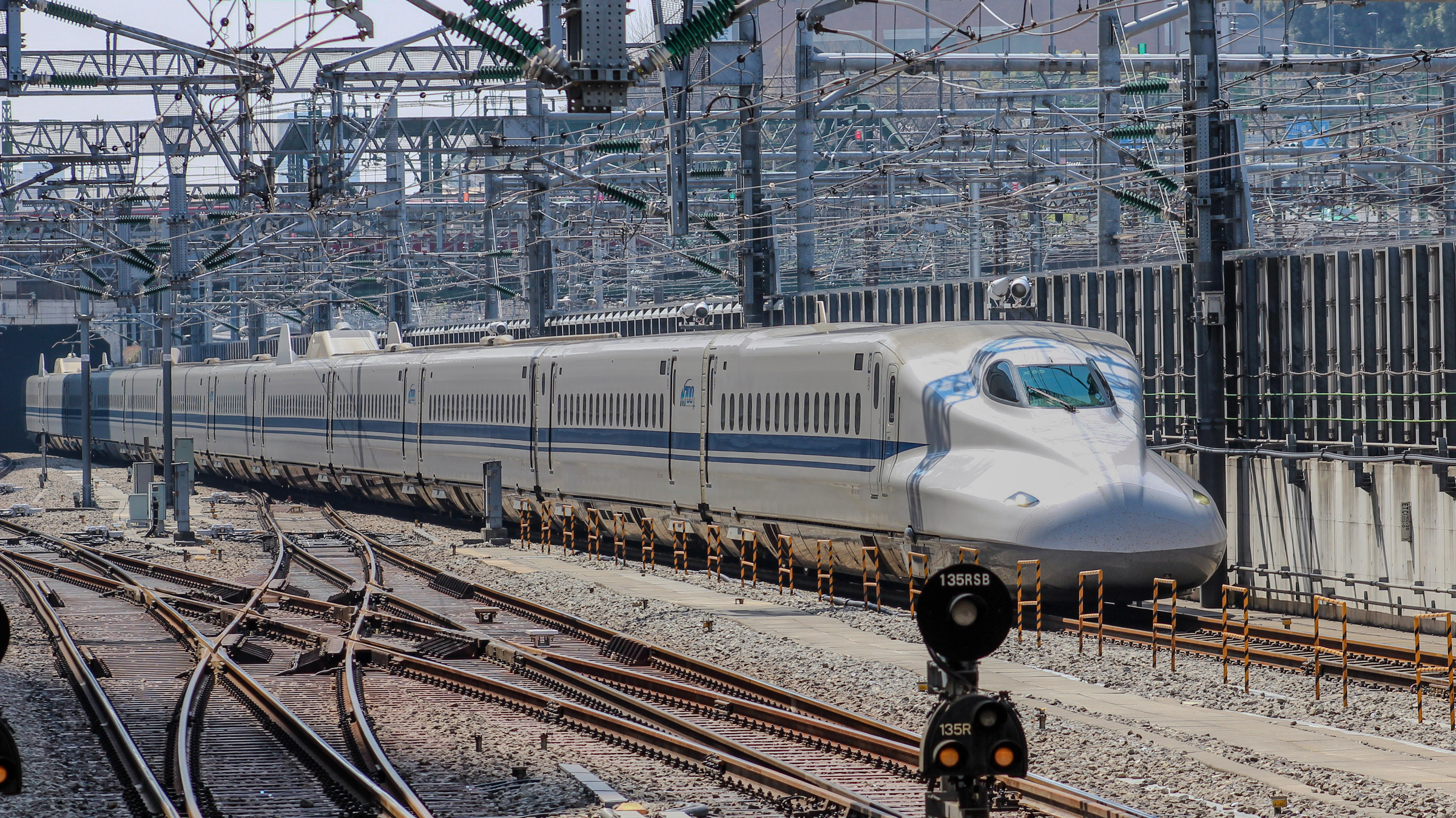 An N700 Shinkansen rounds curved tracks near Shinagawa in Tokyo.